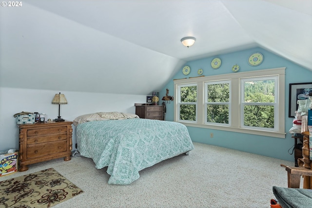 carpeted bedroom with vaulted ceiling