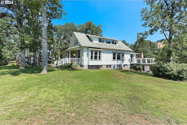 rear view of property with a lawn and covered porch