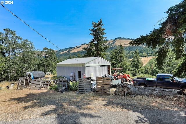 view of side of property featuring a garage and an outdoor structure