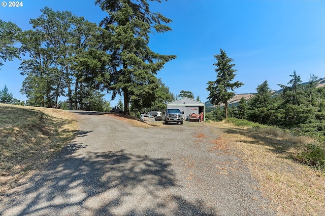 view of road with gravel driveway