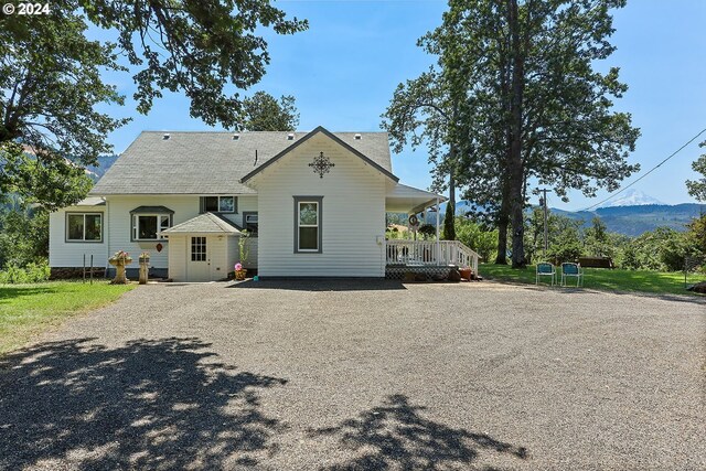 back of property featuring a mountain view