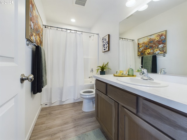 full bathroom with shower / bath combination with curtain, toilet, vanity, and hardwood / wood-style floors