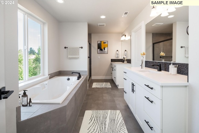 bathroom with vanity and independent shower and bath