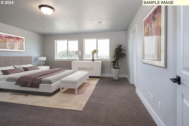 bedroom featuring carpet flooring and a textured ceiling