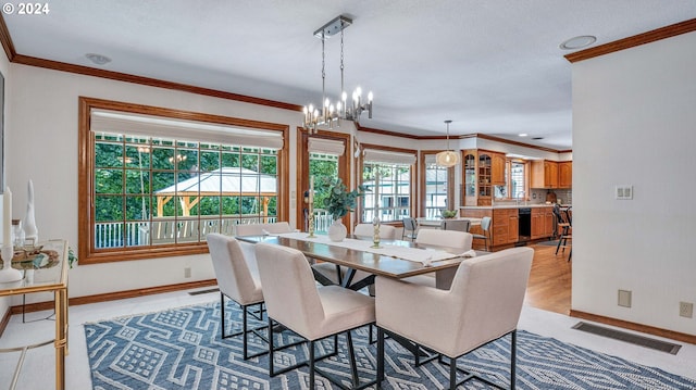 dining room featuring ornamental molding and an inviting chandelier