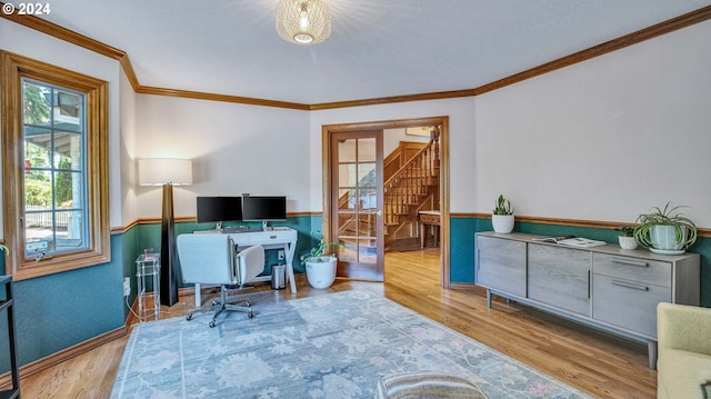 office area with light hardwood / wood-style flooring and crown molding