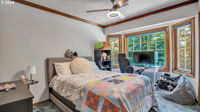 carpeted bedroom with ceiling fan, crown molding, and a textured ceiling