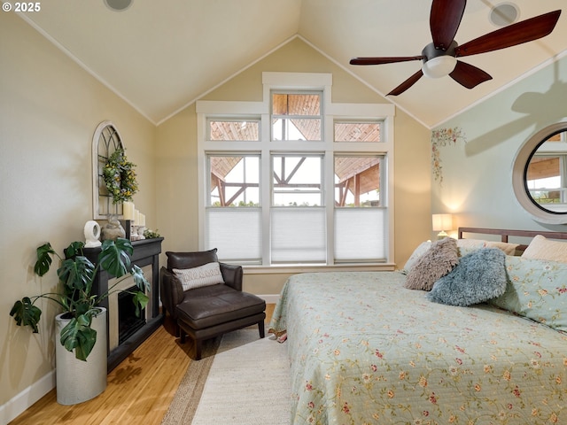 bedroom featuring ceiling fan, lofted ceiling, and hardwood / wood-style flooring