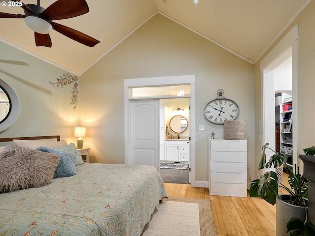 bedroom with hardwood / wood-style floors, connected bathroom, vaulted ceiling, ceiling fan, and ornamental molding