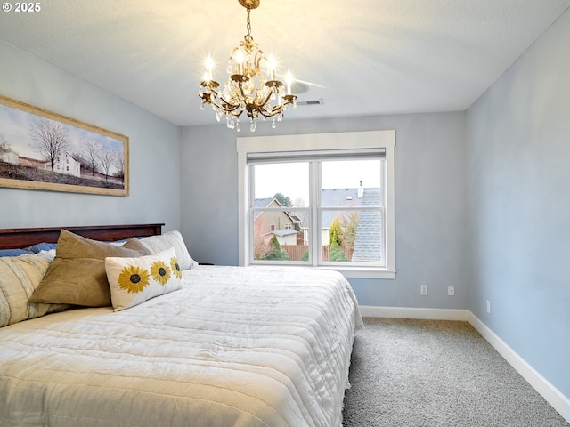 bedroom featuring carpet and a notable chandelier