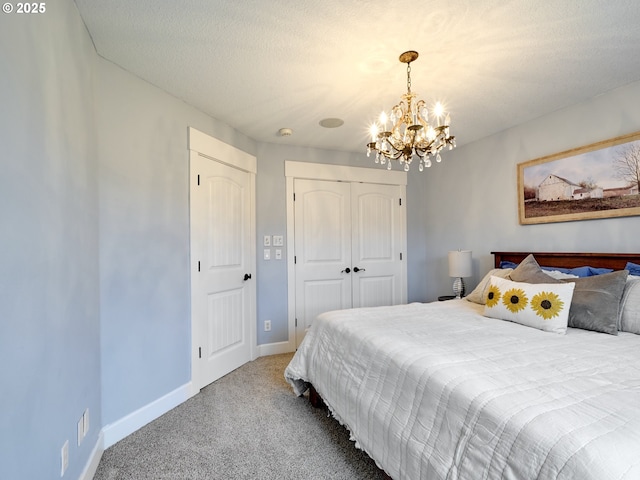 carpeted bedroom featuring a closet and an inviting chandelier