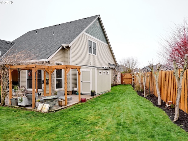 rear view of house with a patio, a yard, and a storage shed