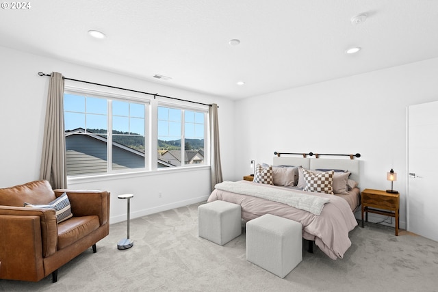 bedroom featuring light colored carpet