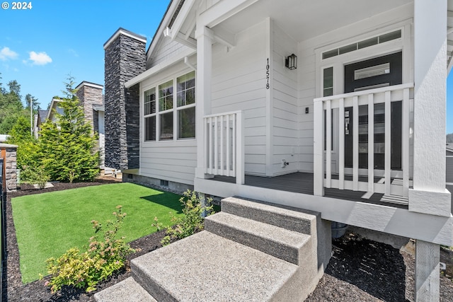 property entrance featuring a lawn