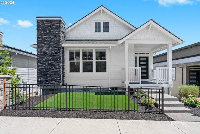 view of front of home with a porch and a front lawn