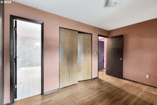 unfurnished bedroom featuring light hardwood / wood-style floors and a closet