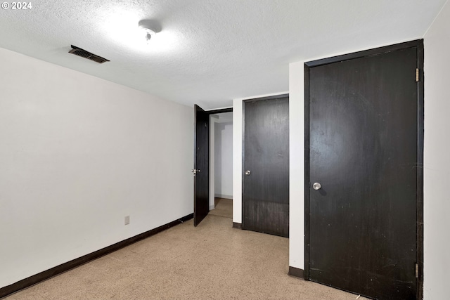 unfurnished bedroom with a closet and a textured ceiling