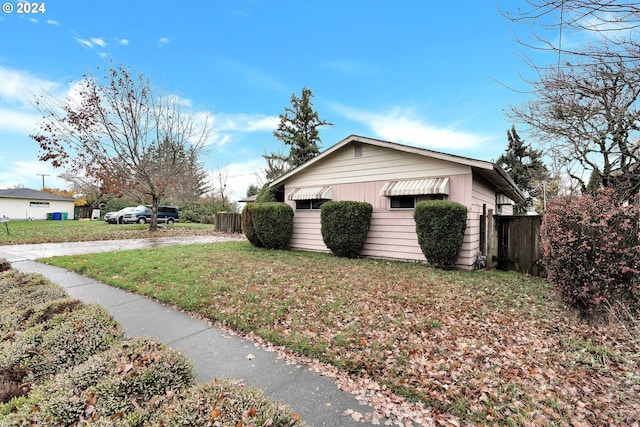 view of property exterior featuring a lawn