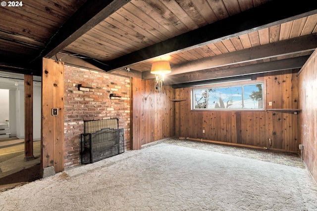 unfurnished living room featuring carpet flooring, beam ceiling, wood ceiling, and wooden walls