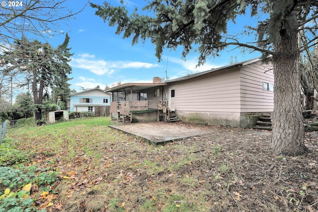 back of house with a patio