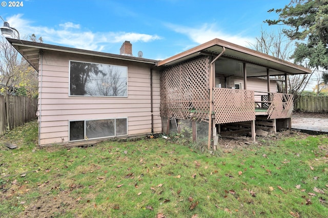 rear view of property with a yard