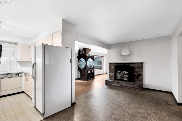 kitchen with white appliances, light hardwood / wood-style flooring, white cabinetry, and a wealth of natural light