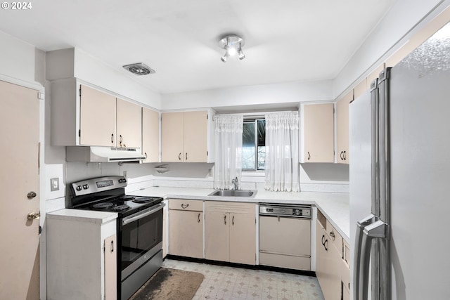 kitchen with sink, appliances with stainless steel finishes, and cream cabinets