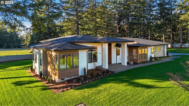 rear view of house with a yard