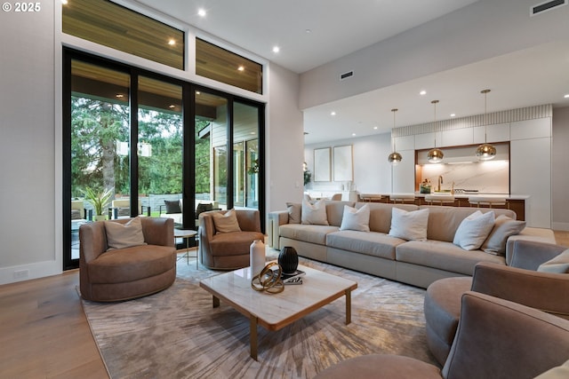 living room with expansive windows and light wood-type flooring