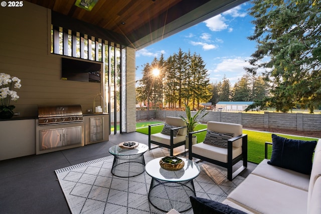 view of patio featuring area for grilling, an outdoor living space with a fire pit, and grilling area