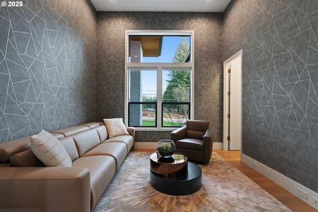 living room featuring hardwood / wood-style flooring and tile walls