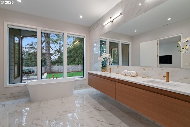 bathroom with vanity and a bath