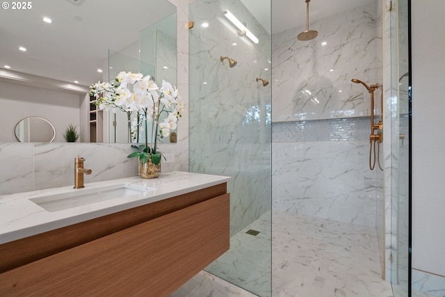 bathroom featuring tasteful backsplash, vanity, and tiled shower