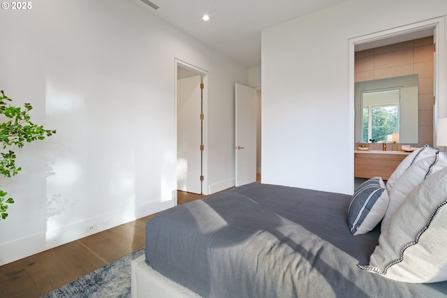 bedroom featuring wood-type flooring and ensuite bathroom