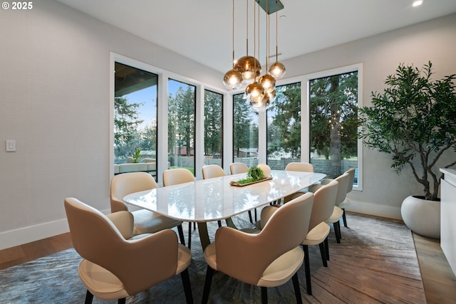 dining room with a notable chandelier and hardwood / wood-style floors