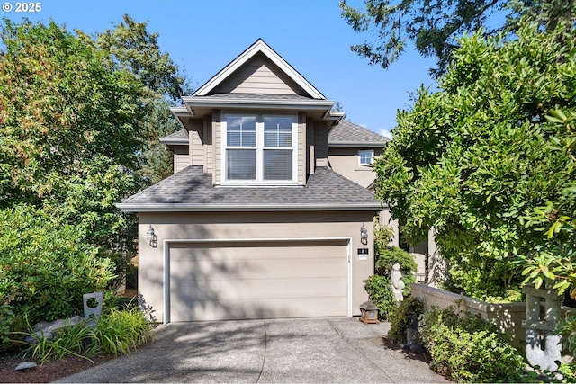 view of front of house with a garage, a shingled roof, driveway, and stucco siding