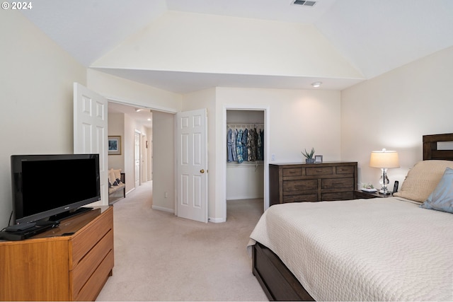 bedroom featuring lofted ceiling, a spacious closet, visible vents, a closet, and light colored carpet