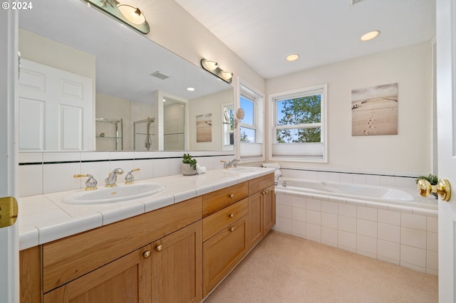 bathroom with double vanity, visible vents, a sink, a garden tub, and a stall shower