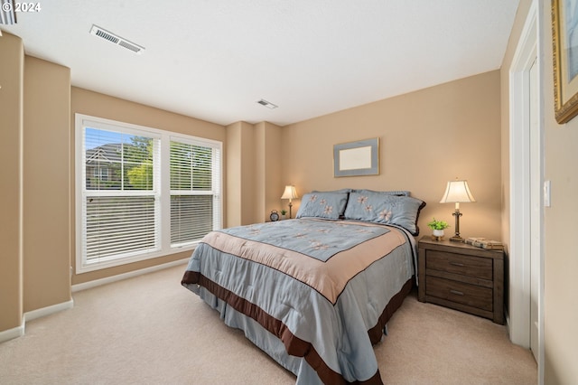 bedroom featuring light carpet