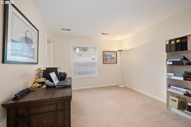 home office with light colored carpet, baseboards, and visible vents
