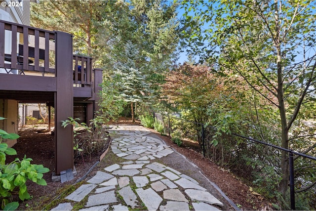 view of yard featuring fence and a deck