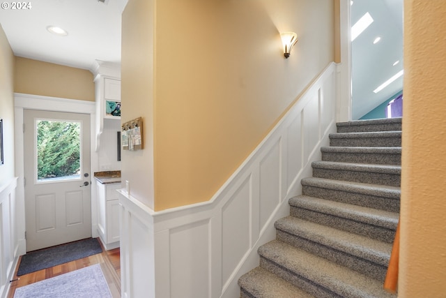 stairs featuring wood-type flooring