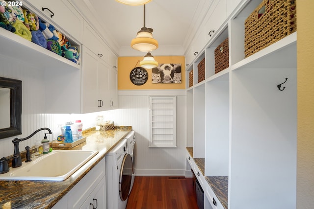 kitchen featuring white cabinetry, sink, hanging light fixtures, and dark stone countertops