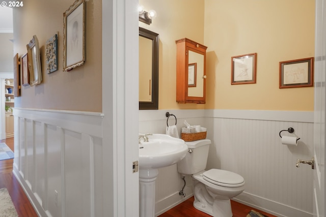 bathroom with wood-type flooring, toilet, and sink