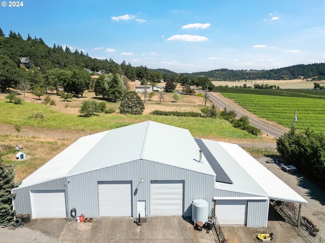 view of outbuilding featuring a garage and a rural view