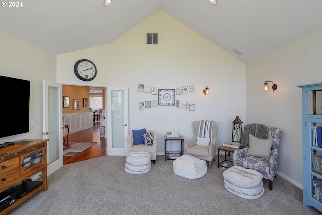 sitting room with french doors, high vaulted ceiling, and carpet floors