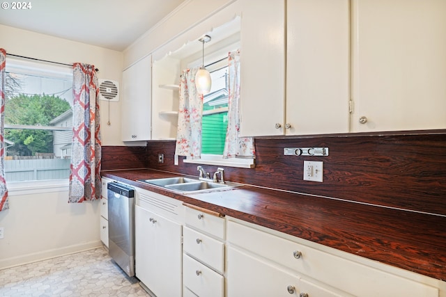 kitchen with white cabinetry, stainless steel dishwasher, sink, and hanging light fixtures