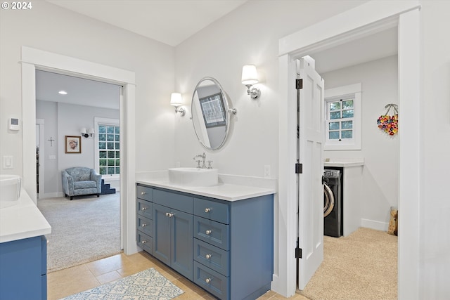 bathroom with washer / dryer, tile patterned floors, and vanity