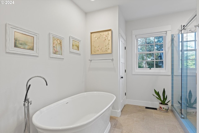 bathroom featuring shower with separate bathtub