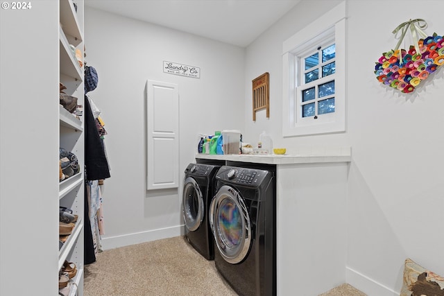 washroom featuring washer and dryer and light colored carpet